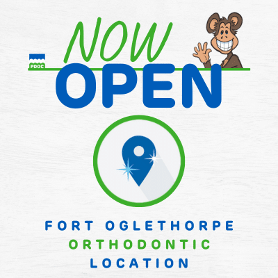 Graphic with cartoon monkey waving with text that says Now Open Fort Oglethorpe Location