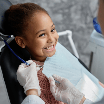 Relieving Jaw Pain With Orthodontics 7 Little girl at orthodontist, smiling
