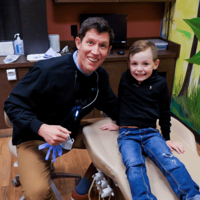 Comprehensive Pediatric Dental Services at PDOC 2 Pediatric dentist posing for a photo with young boy patient, representing dental services