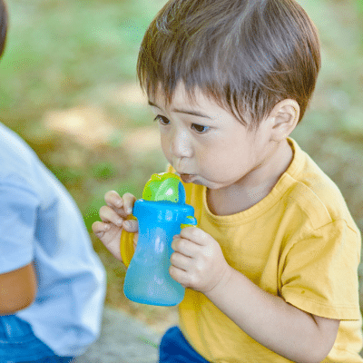 The Impact of Sippy Cups and Dental Health: How Prolonged Use Can Affect Teeth and Tips for Transitioning to Regular Cups 7 a child drinking from a sippy cup, representing Sippy cups and dental health